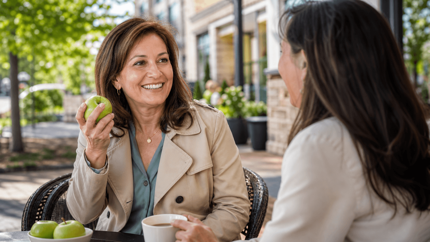Smiling older couple enjoy coffee together in a bright modern kitchen with soft natural light.